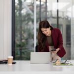 Property manager reviewing centralized systems on a laptop, representing centralization in multifamily property management