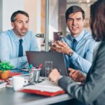 Multifamily property management team discussing automated workflows during a meeting, representing automation in multifamily property management