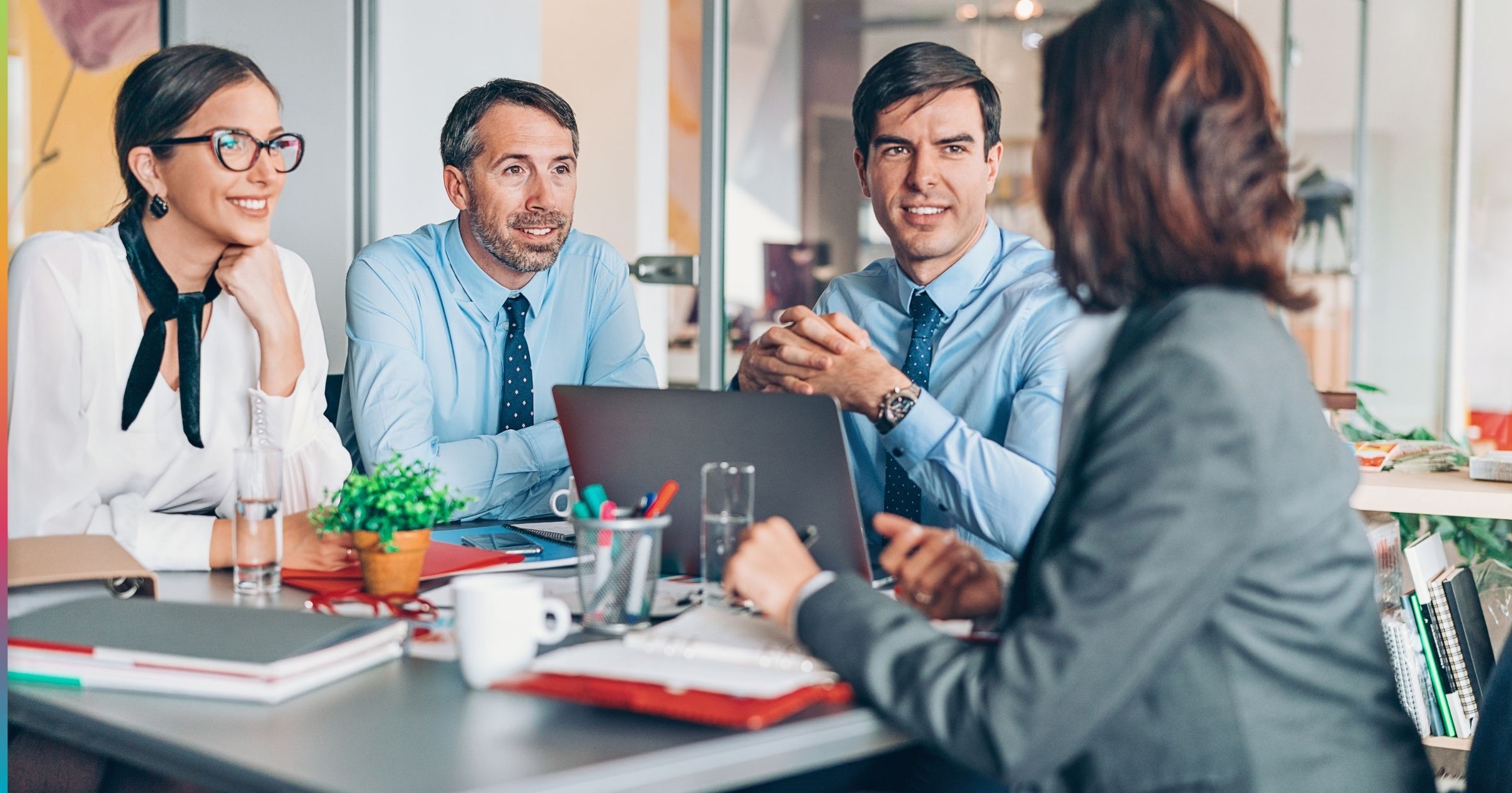 Multifamily property management team discussing automated workflows during a meeting, representing automation in multifamily property management