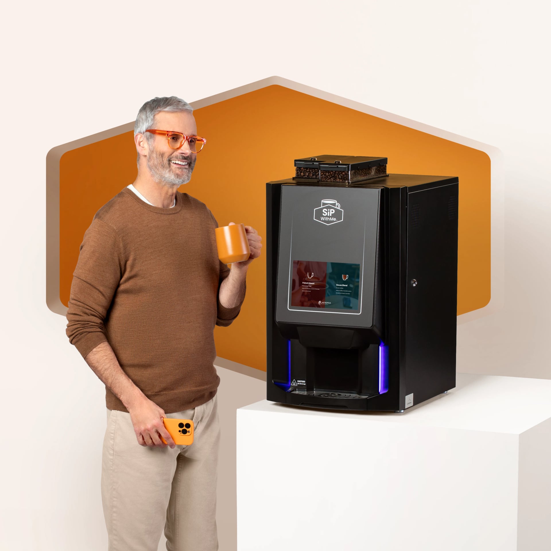 Hotel guest holding coffee beside a SipWithMe bean-to-cup coffee machine