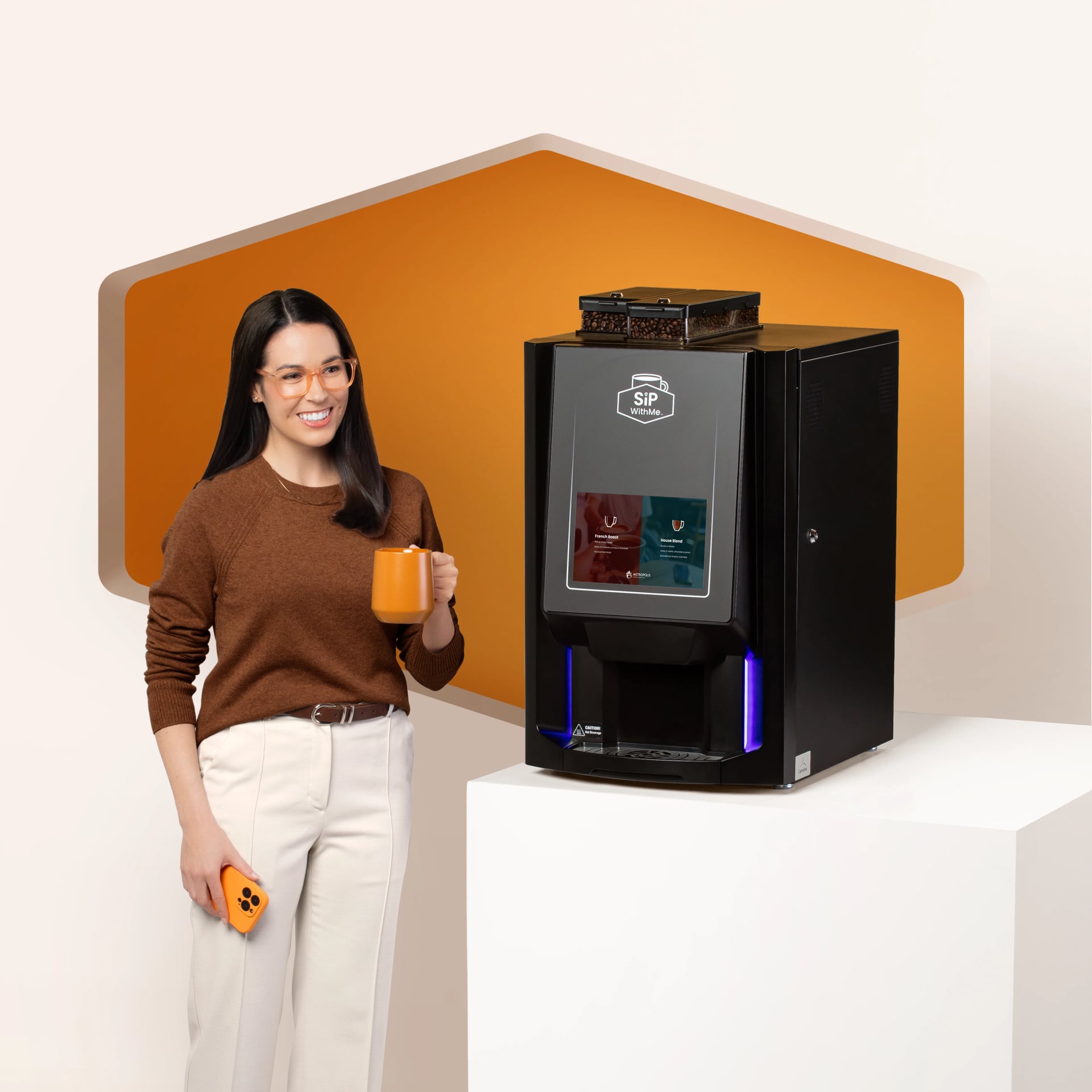 Woman holding coffee beside a SipWithMe bean-to-cup coffee machine