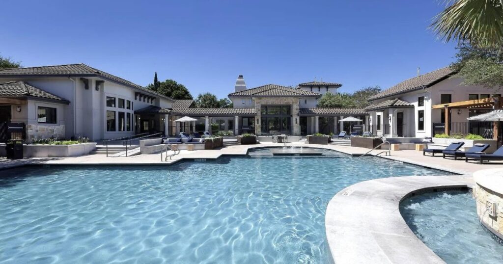 Swimming pool and sundeck outside the clubhouse at Toscana apartments in Austin, Texas